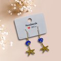 Boucles d’oreilles dormeuses dorées – Étoile de mer & cœur en verre de Murano